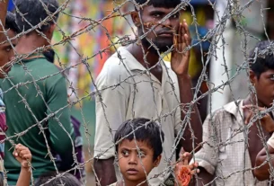 File image: Rohingya refugees stand behind barbed wires at Kutupalong refugee camp on September 9, 2024. Photo: AFP